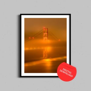 May include: A photograph of the Golden Gate Bridge in San Francisco, California, at night. The bridge is illuminated with orange lights and is partially obscured by fog. The fog is thick and creates a hazy effect around the bridge. The bridge is a popular tourist destination and is a symbol of San Francisco.