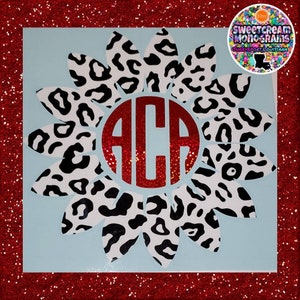 May include: A white and black leopard print flower with a red glitter monogram in the center. The monogram is the letters "ACA".