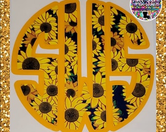 May include: A yellow circle monogram with the letters "S" and "W" inside. The background of the monogram is a pattern of yellow sunflowers on a dark blue background.