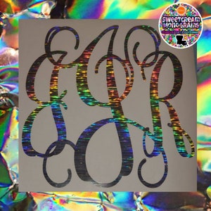 May include: A black and silver iridescent vinyl monogram with the letters "KAR" in a script font.