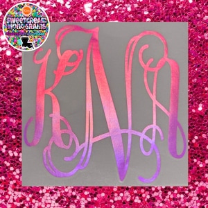 May include: A pink and purple ombre monogram with the letters "K A R" in a cursive script font.