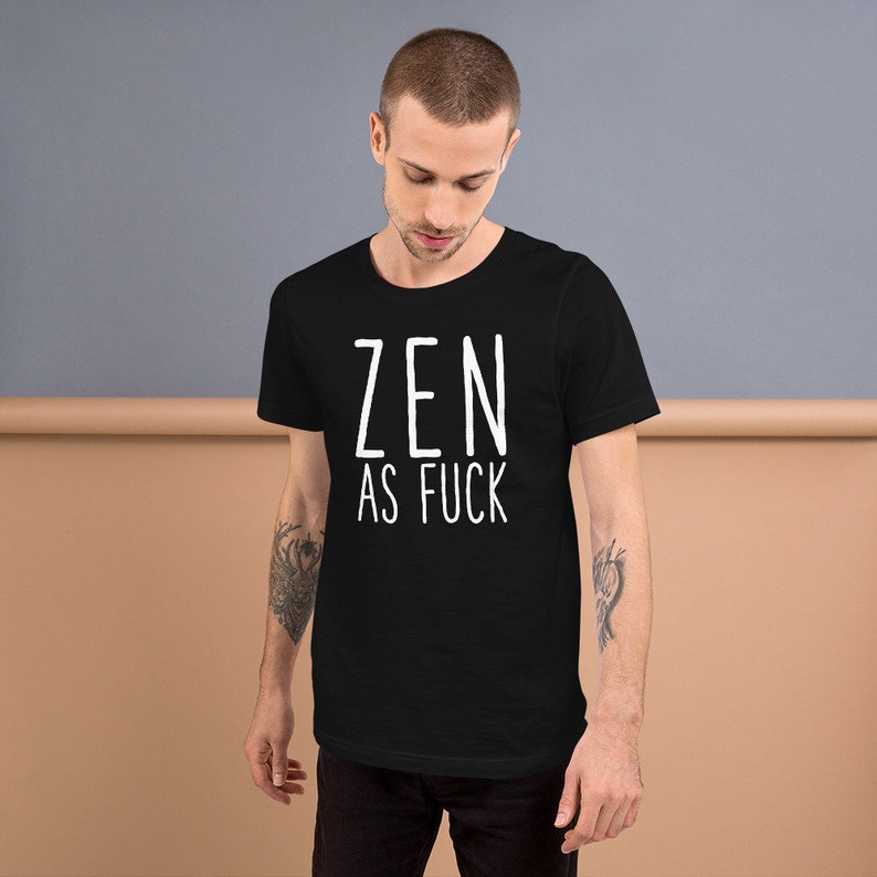 May include: A black t-shirt with the text "ZEN AS FUCK" printed in white on the front.