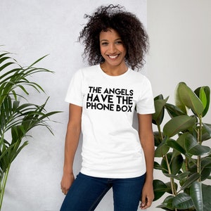 May include: White t-shirt with black text that reads "THE ANGELS HAVE THE PHONE BOX"