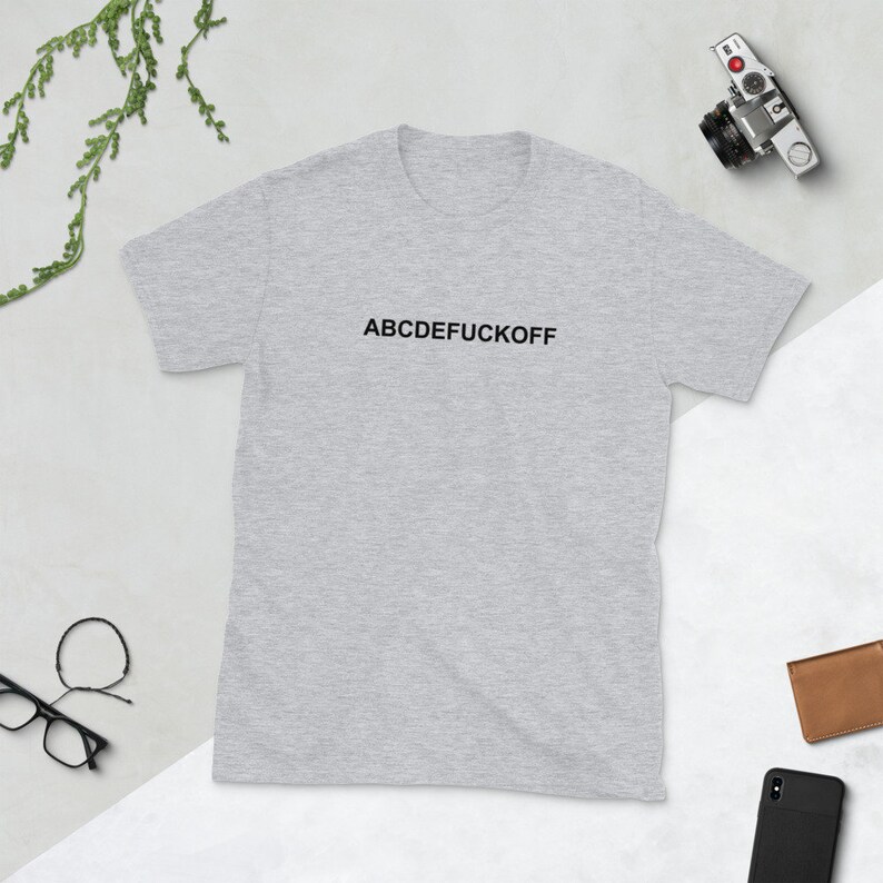 May include: A gray short-sleeved t-shirt with the text "ABCDEFUCKOFF" printed in black on the front.