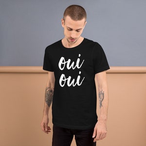 May include: A black t-shirt with the words "oui oui" printed in white on the front.