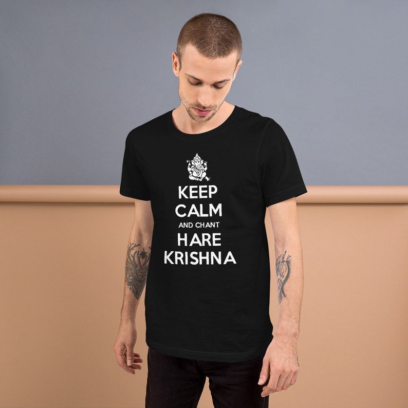 May include: Black t-shirt with a white graphic that says "Keep Calm and Chant Hare Krishna" with a small image of a Hindu deity above the text.