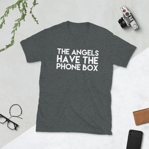 May include: A dark heather grey t-shirt with the text "THE ANGELS HAVE THE PHONE BOX" printed in white.