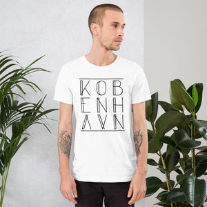 May include: A white t-shirt with a black graphic design that says "KOBENHAVN" in a stylized font.