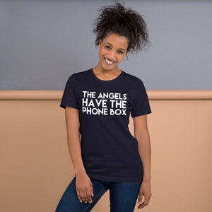 May include: A navy blue t-shirt with white text that reads "THE ANGELS HAVE THE PHONE BOX".