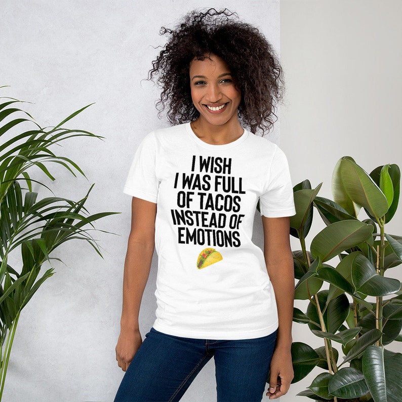 May include: White t-shirt with black text that reads "I wish I was full of tacos instead of emotions". A yellow taco graphic is below the text.