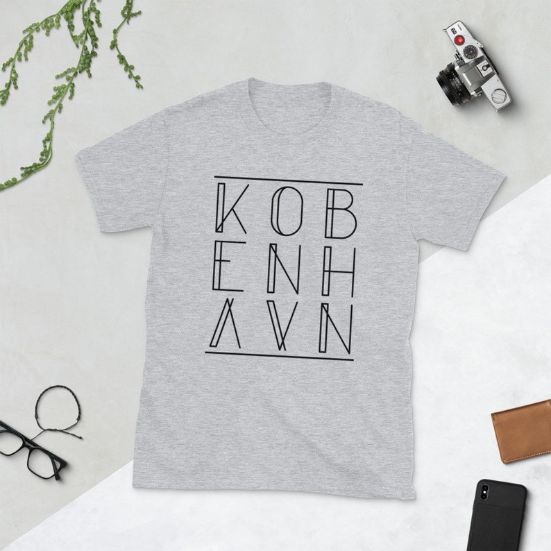 May include: Gray t-shirt with black text that reads "KOBENHAVN" in a geometric font.
