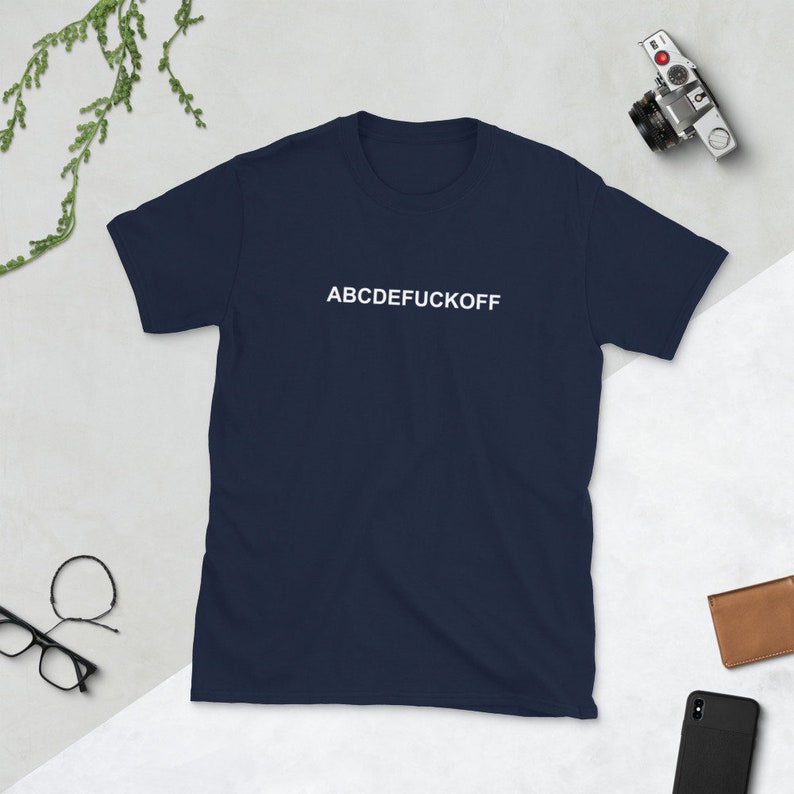 May include: A navy blue t-shirt with the text "ABCDEFUCKOFF" printed in white on the front.