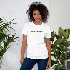 May include: White t-shirt with black text that reads "ABCDEFUCKOFF".