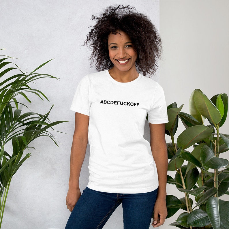 May include: White t-shirt with black text that reads "ABCDEFUCKOFF".