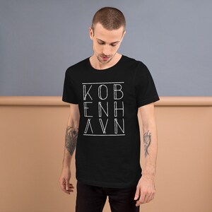 May include: Black t-shirt with a white graphic design that says "KOBENHAVN" in a geometric font.