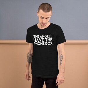 May include: Black t-shirt with white text that reads "THE ANGELS HAVE THE PHONE BOX"