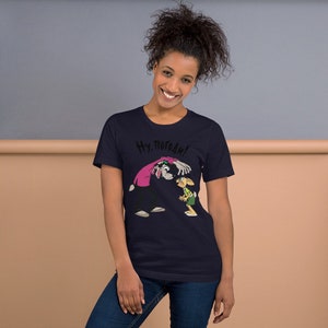 May include: A navy blue t-shirt with a cartoon image of a wolf and a rabbit. The wolf is wearing a pink shirt and the rabbit is wearing a green shirt. The text "Ну, погоди!" is printed on the shirt.