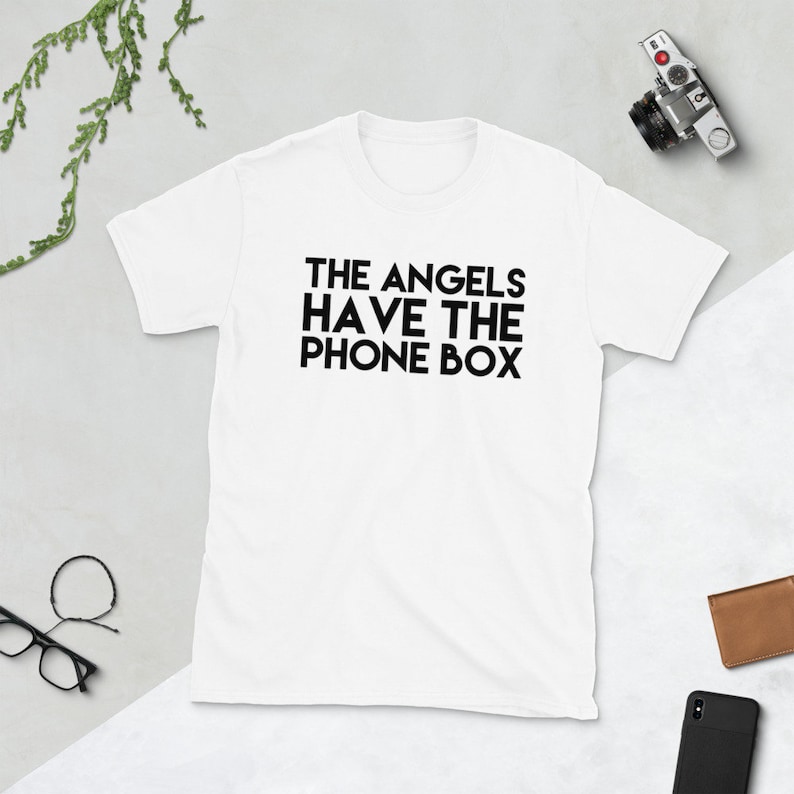 May include: White t-shirt with black text that reads "THE ANGELS HAVE THE PHONE BOX"