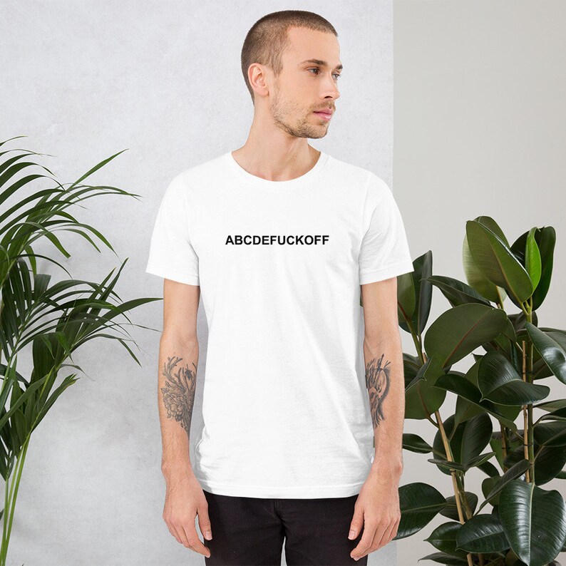 May include: White t-shirt with the text "ABCDEFUCKOFF" printed in black.