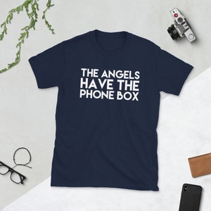 May include: A navy blue t-shirt with white text that reads "THE ANGELS HAVE THE PHONE BOX".
