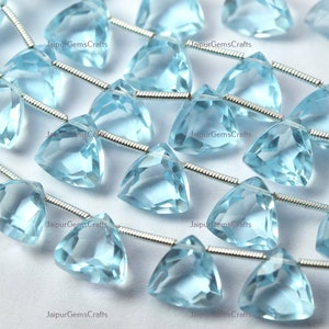 May include: A strand of light blue triangular gemstone beads with silver wire.