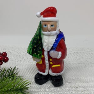 Adorable Christmas Decor ~ Art Glass Santa Claus Figurine by Lampwork ~ Christmas Santa Claus is Holding a Tree and Toy Bag.