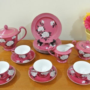 Nippon Noritake Toki Kaisha Porzellan Fine China Tee-Set, satte rosa Farbe mit einem weißen Pfingstrosen-Blüten-Muster und Goldzier.