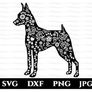 May include: Black and white silhouette of a dog with a floral pattern. The dog is standing on all four legs with its head turned to the left. The floral pattern is intricate and includes flowers, leaves, and swirls.