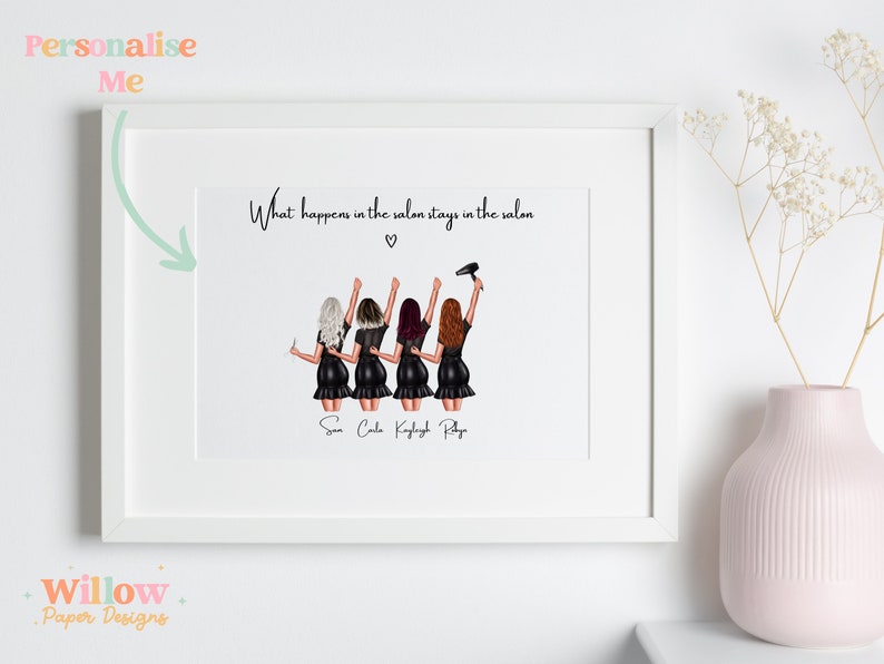May include: A white framed print with a black and white illustration of four women in black dresses and hair styling tools. The text "What happens in the salon stays in the salon" is at the top of the print. The names "Sun, Cole, Kaylyt, Ray" are written below the illustration.