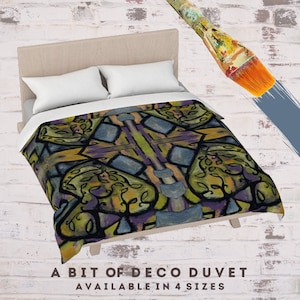 May include: A duvet cover with a geometric pattern in shades of yellow, green, purple, and blue. The pattern is reminiscent of Art Deco style. The text "A BIT OF DECO DUVET AVAILABLE IN 4 SIZES" is at the bottom of the image.