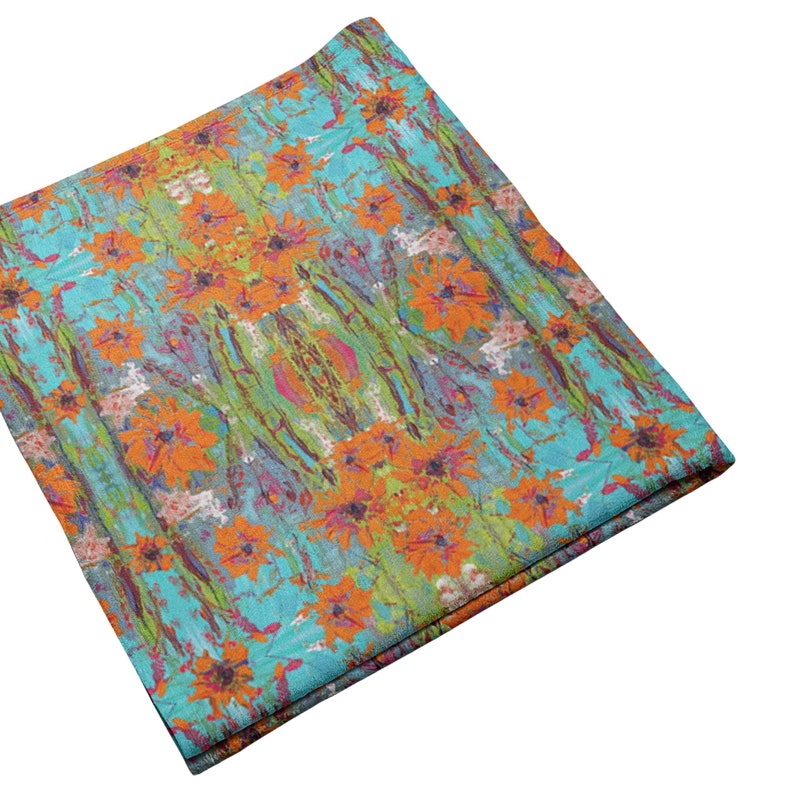 May include: A turquoise fabric with a colorful floral pattern. The fabric features orange, yellow, green, and pink flowers on a turquoise background.