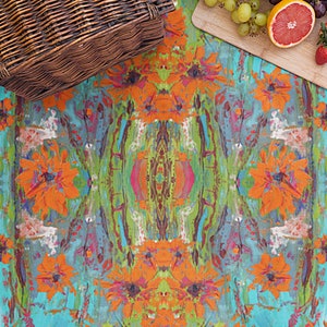 May include: A colorful picnic blanket with a floral pattern featuring orange flowers and green leaves on a turquoise background.