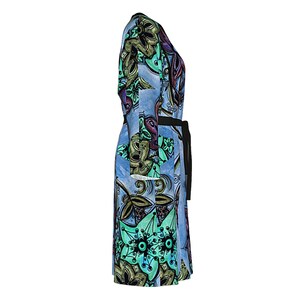 May include: A blue and green floral print wrap dress with a black belt. The dress has a long sleeve and a v-neck.