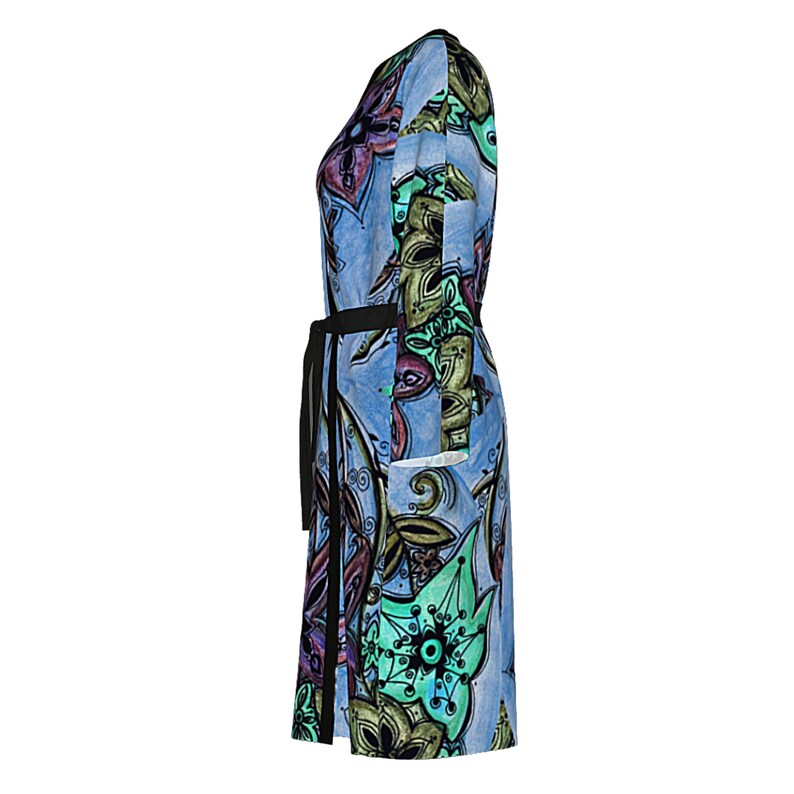 May include: A blue dress with a colorful floral pattern and a black belt. The dress has a long sleeve and a knee-length hem.