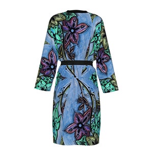 May include: A long-sleeved blue robe with a black belt and a floral print in shades of green, purple, and brown.