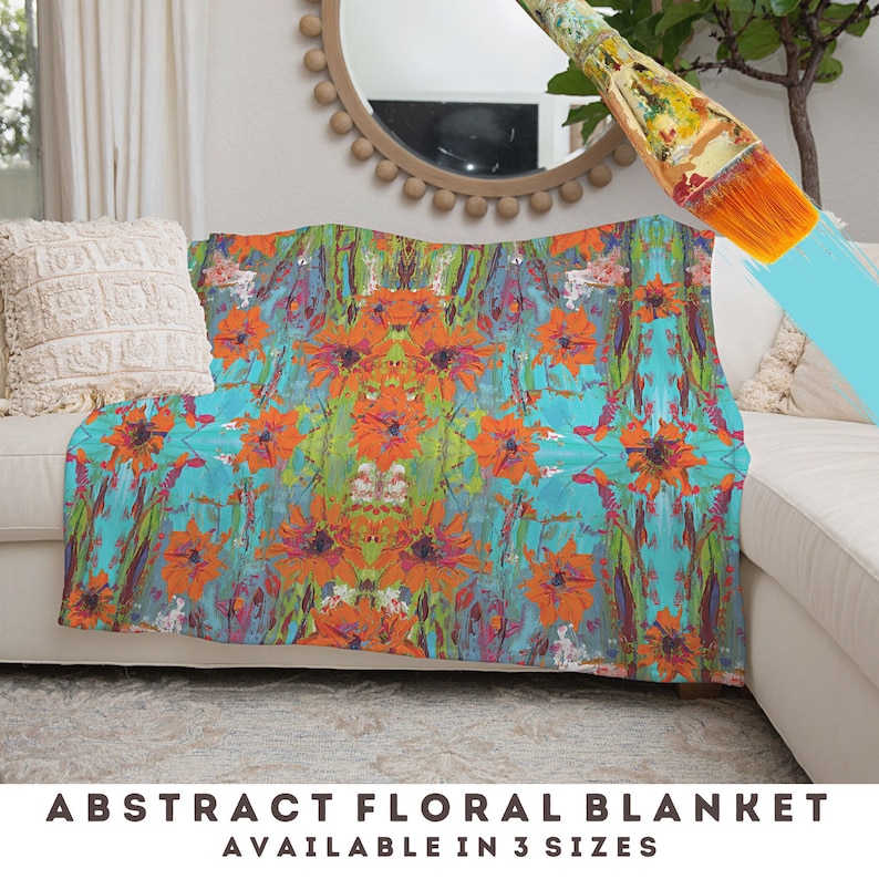 May include: Abstract floral throw blanket with a vibrant orange, turquoise, and green color scheme. The blanket features a repeating pattern of stylized flowers.