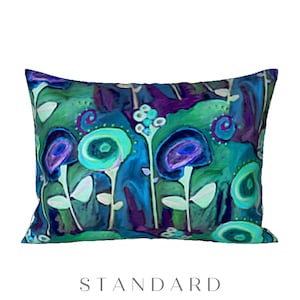 May include: A decorative throw pillow with a colorful abstract floral design. The pillow features a blue, green, and purple color scheme with swirling patterns and circles.