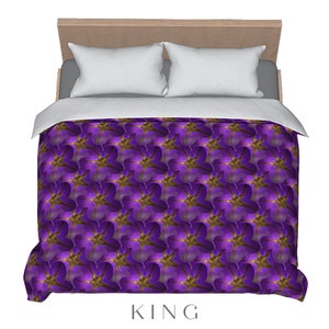 May include: Purple and gold floral patterned king-size duvet cover.