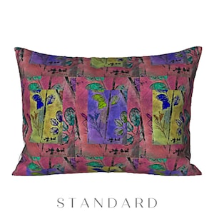 May include: A pink pillow with a repeating pattern of colorful floral designs. The pillow has a standard size.