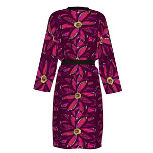 May include: A long, purple robe with a black belt and a floral print of pink and green flowers.