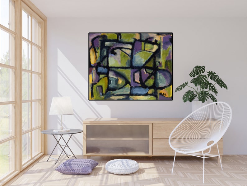May include: Abstract painting with geometric shapes in shades of green, purple, blue, and yellow. The painting is framed in black and hangs on a white wall in a living room setting.
