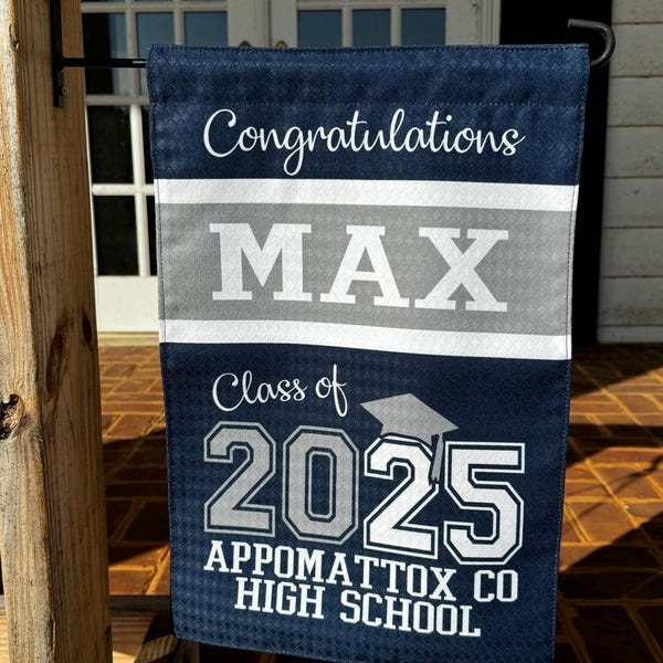 May include: A blue and grey graduation garden flag with the text "Congratulations Max Class of 2025 Appomattox Co High School".
