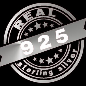 May include: A silver stamp with the words "REAL STERLING SILVER" and the number "925" in white.