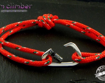 May include: Red and green rope bracelet with a silver carabiner clasp. The bracelet is made of a thick, braided rope with a knot at the end. The clasp is a silver hook with a small silver ring. The bracelet is labeled "i'm climber jewels".