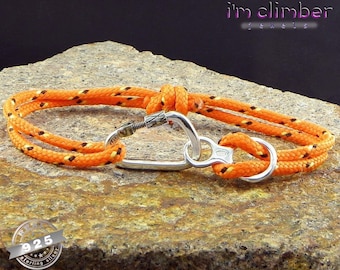 May include: Orange and black rope bracelet with a silver carabiner clasp. The bracelet is made with a double strand of rope and has a silver charm that says "925 Sterling Silver". The bracelet is on a rock surface. The text "i'm climber jewels" is visible in the top right corner of the image.