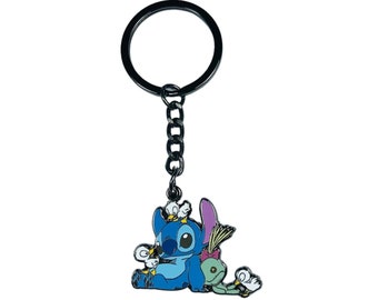 May include: A blue Stitch keychain with a green alien and small white birds. The keychain is attached to a silver metal ring.