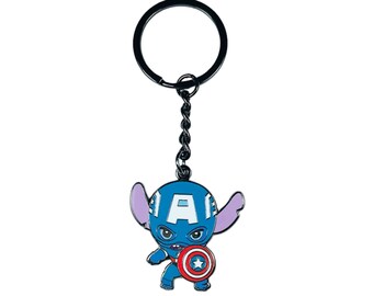 May include: A black metal keychain featuring a blue Stitch character dressed as Captain America. Stitch is wearing a red, white, and blue helmet with a large "A" on the front and holding a red, white, and blue shield with a white star.
