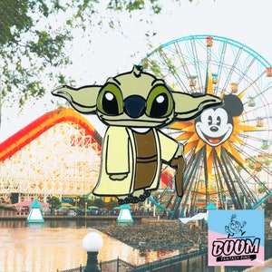 May include: A green and brown cartoon character wearing a tan robe and holding a cane. The character is standing in front of a Ferris wheel with Mickey Mouse's head on it. The background is a colorful amusement park.