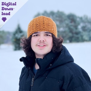 May include: A young person wearing a brown crocheted beanie and a black jacket. The person is standing in a snowy outdoor setting.