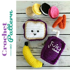 May include: Crochet pattern for a lunchbox with a sandwich, banana, juice box, cookies, and carrots. The sandwich has a cute face.